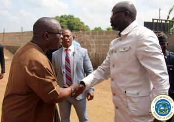 President Weah greets Montserrado District One Representative Lawrence Morris at the dialogueExecutive Mansion
